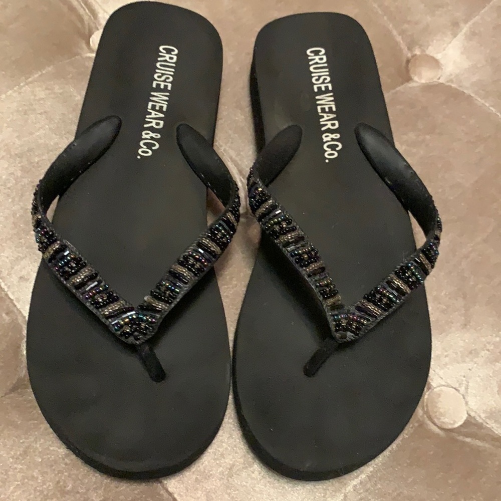 Black foam bottom flip flops with beaded strap
